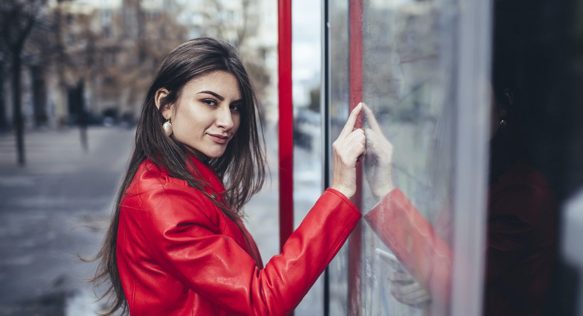 Dreamy woman touching screen of interactive map