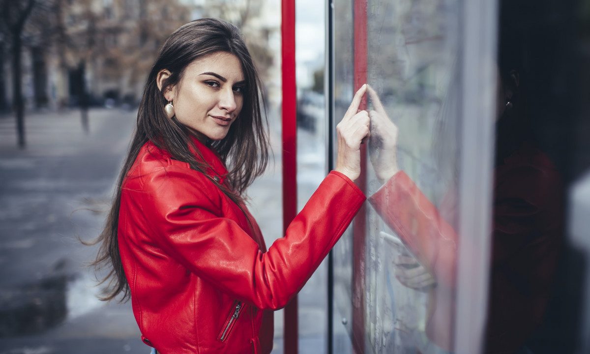 Dreamy woman touching screen of interactive map